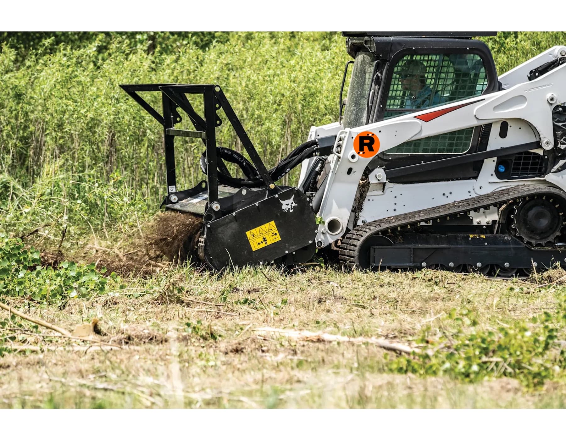 Forestry mulcher clearing a tree on a Florida property